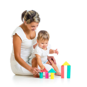 little girl and mother with building blocks